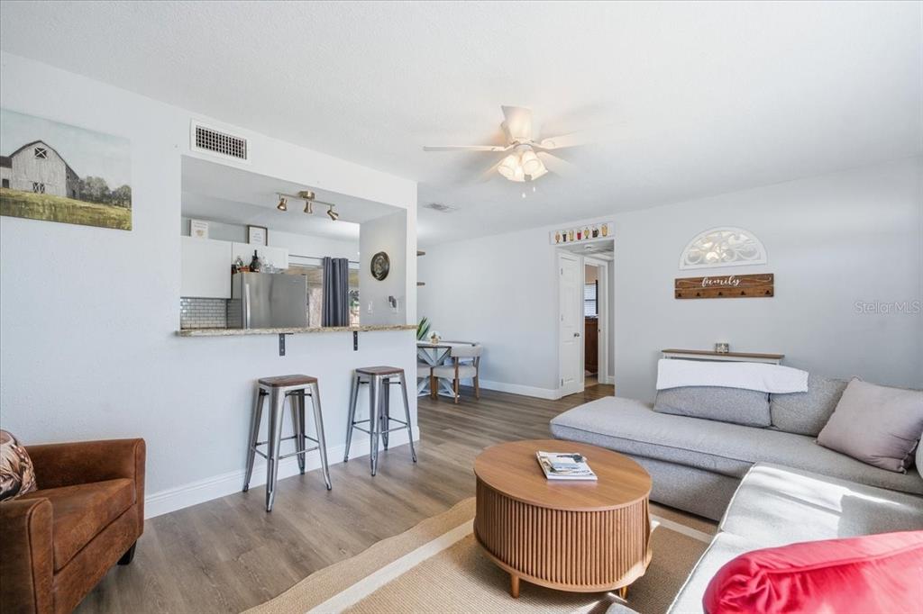3487 Begonia Place Largo, FL 33771 - Photo 10 of 34 a living room with furniture and a wooden floor