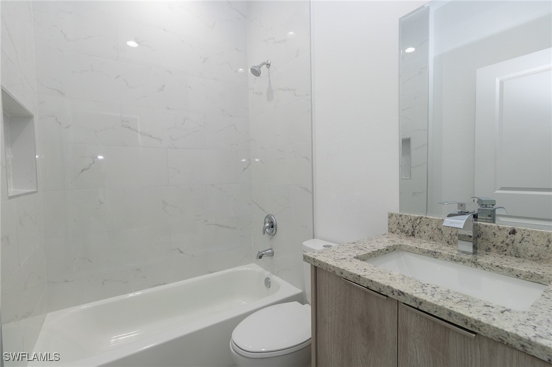 3105 Myra Lane LaBelle, FL 33935 - Photo 15 of 29 a bathroom with a granite countertop sink toilet and shower