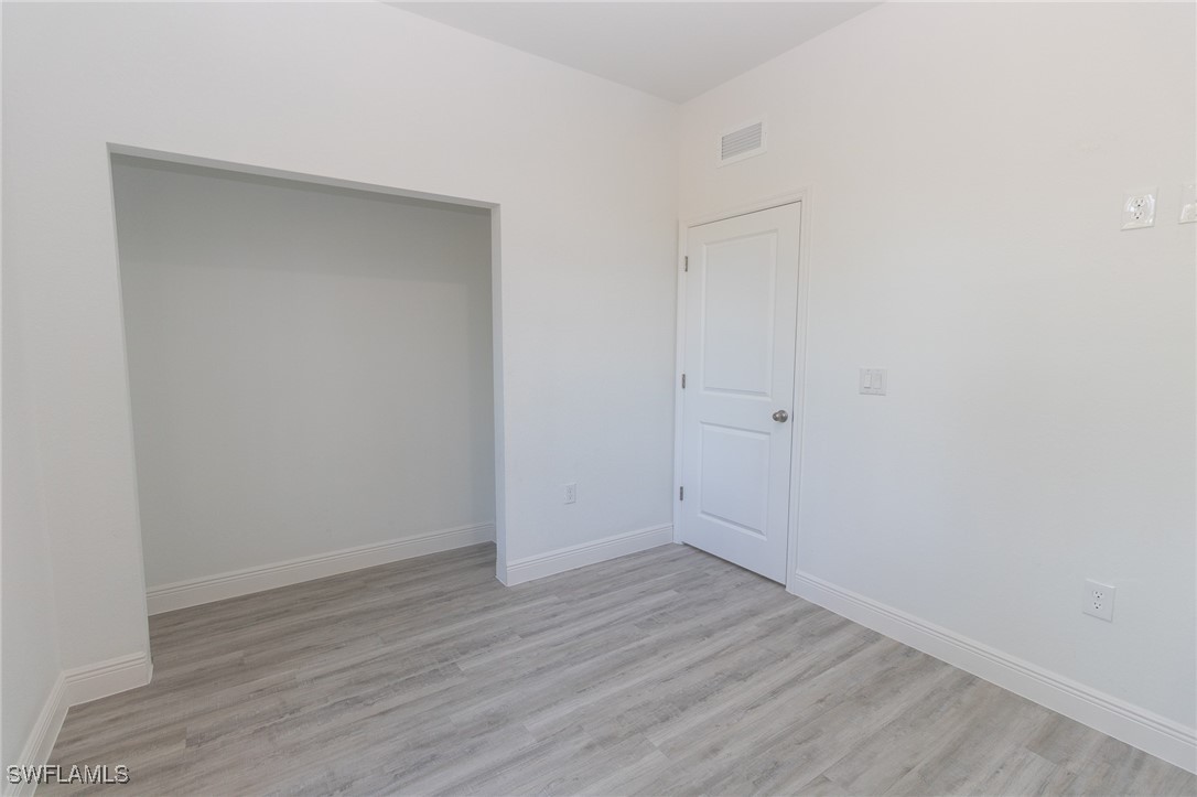 3105 Myra Lane LaBelle, FL 33935 - Photo 16 of 29 a view of an empty room with wooden floor