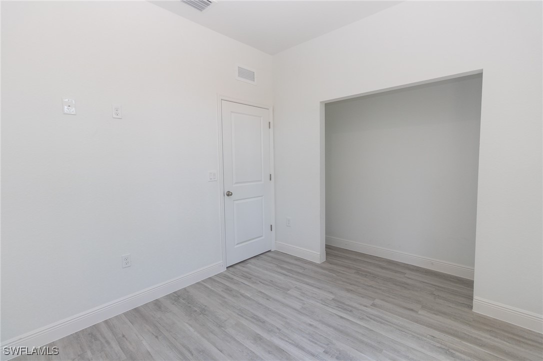 3105 Myra Lane LaBelle, FL 33935 - Photo 18 of 29 a view of an empty room with wooden floor