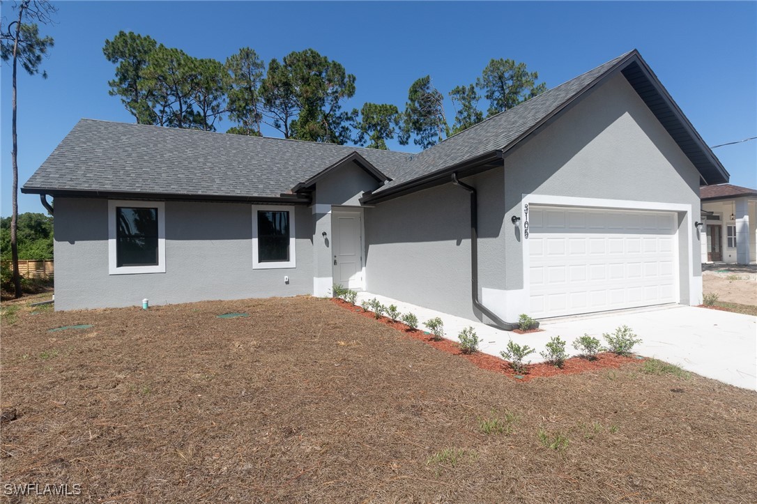 3105 Myra Lane LaBelle, FL 33935 - Photo 2 of 29 a front view of a house with a yard and garage
