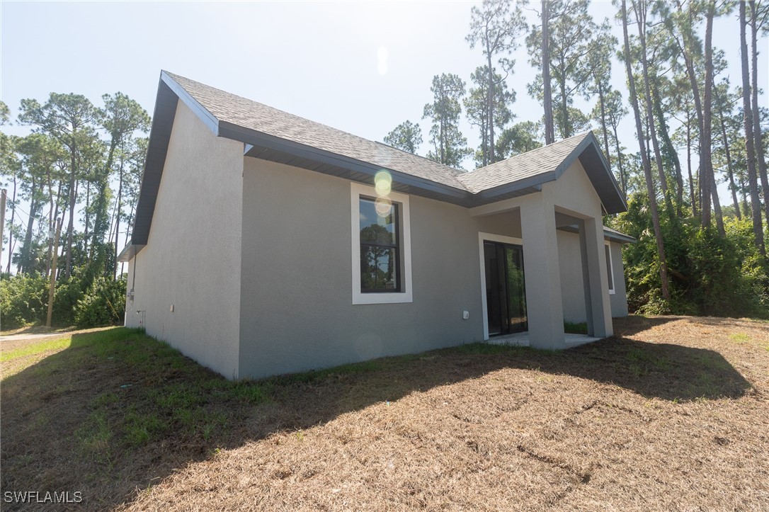 3105 Myra Lane LaBelle, FL 33935 - Photo 25 of 29 a front view of a house with a yard and garage