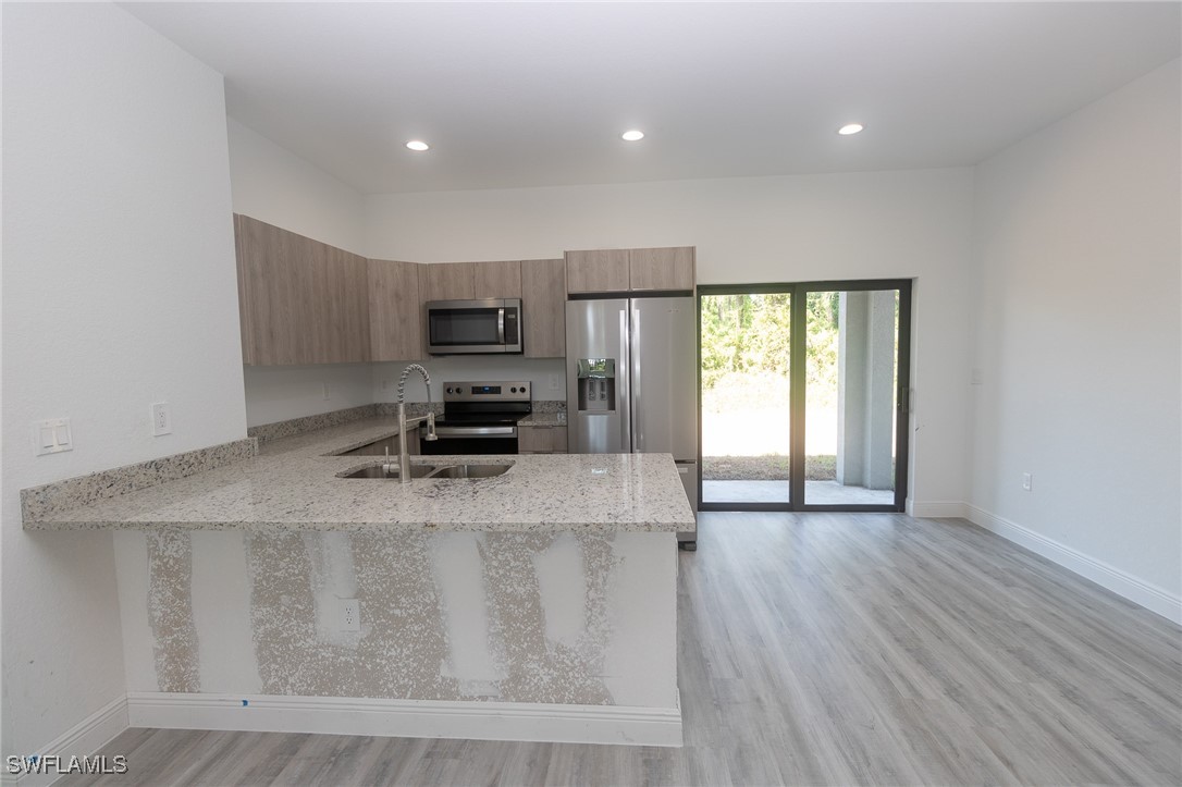 3105 Myra Lane LaBelle, FL 33935 - Photo 9 of 29 a kitchen with a stove a sink and a refrigerator