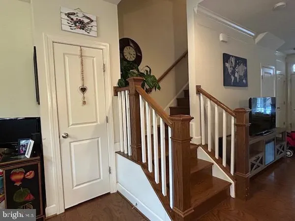 a view of a hallway with entryway wooden floor and front door