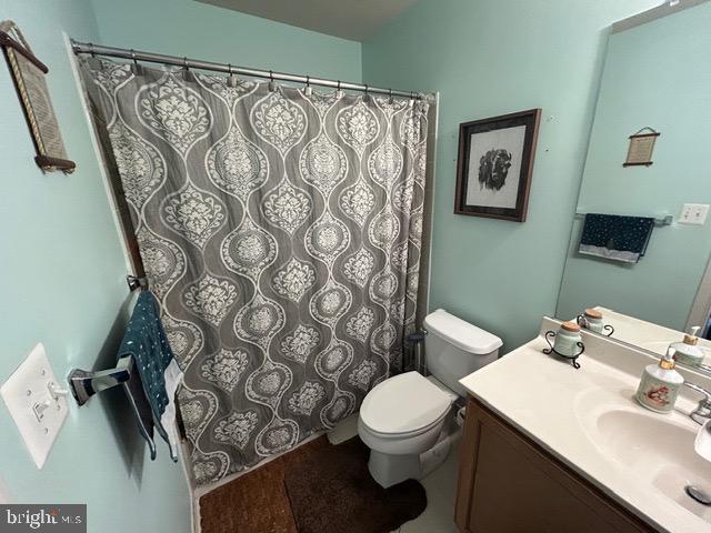 8912 Tawes Street Fulton, MD 20759 - Photo 5 of 21 a bathroom with a toilet sink and mirror