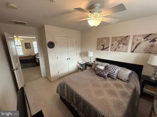 a bedroom with a white bed and a chandelier