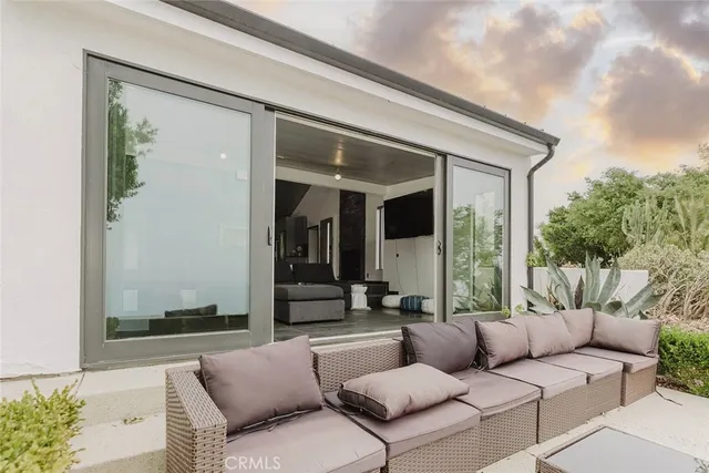 a balcony with furniture and a potted plant