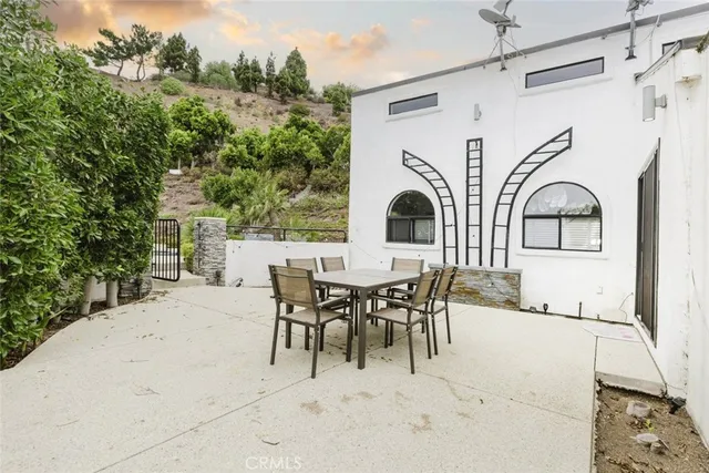 a view of a patio with table and chairs and potted plants