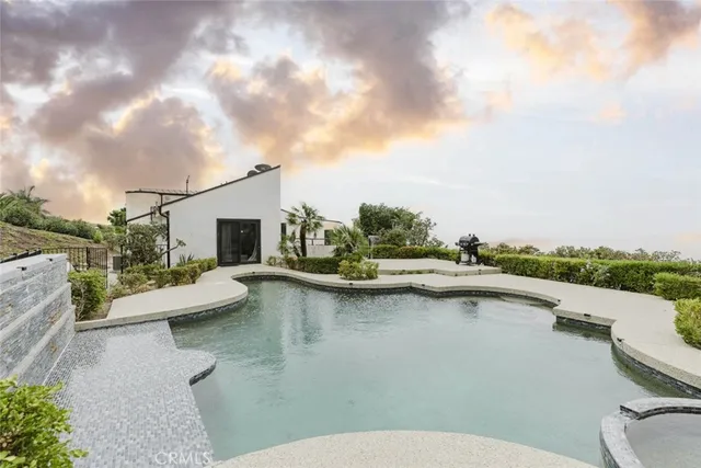 a view of a patio with swimming pool and furniture