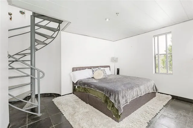 a bedroom with a bed and a window in it