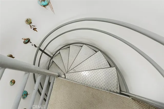 a bedroom with a bed window and potted plant on table