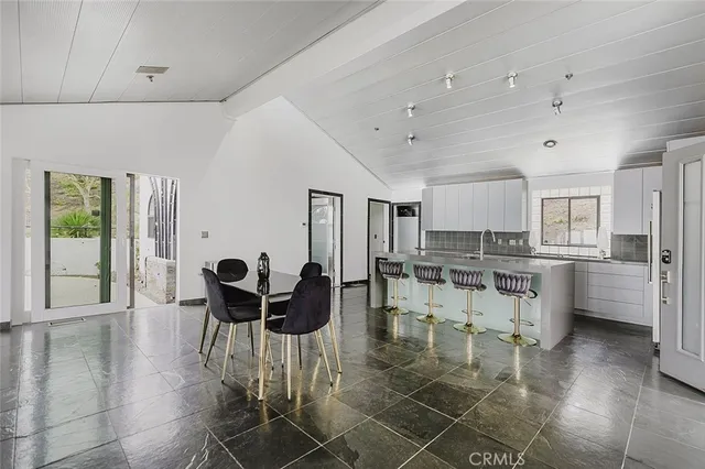 a living room with furniture a dining table and kitchen view