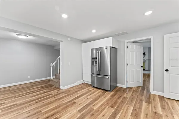 a view of kitchen refrigerator cabinet and wooden floor
