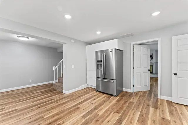 a view of a room with wooden floor closet and windows