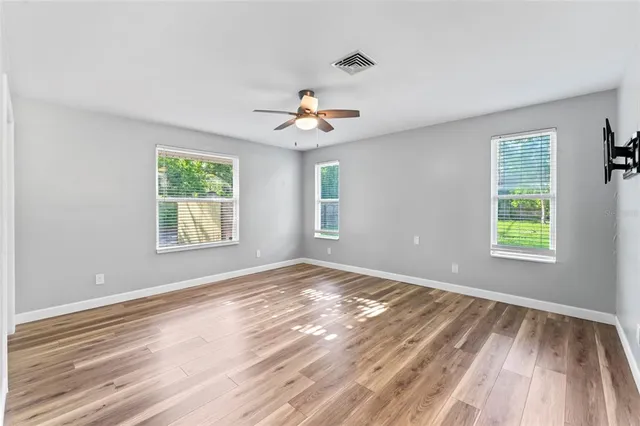 a view of kitchen with wooden floor and electronic appliances