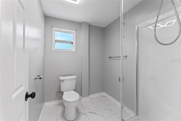 a bathroom with a toilet sink and shower