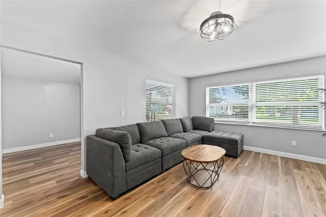 a living room with furniture a window and a table