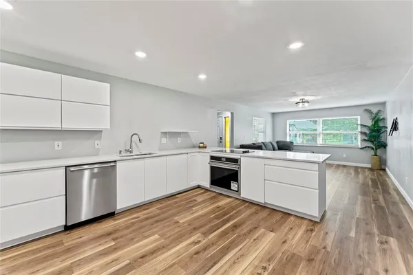 a kitchen with white cabinets and white appliances