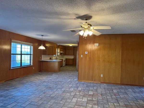a view of a kitchen with a chandelier fan and a kitchen view