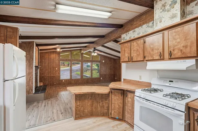a kitchen with a stove and a refrigerator
