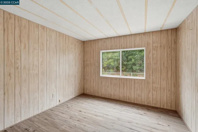 a view of a room with wooden floor and windows