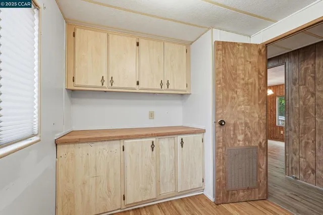 a view of cabinets and wooden floor