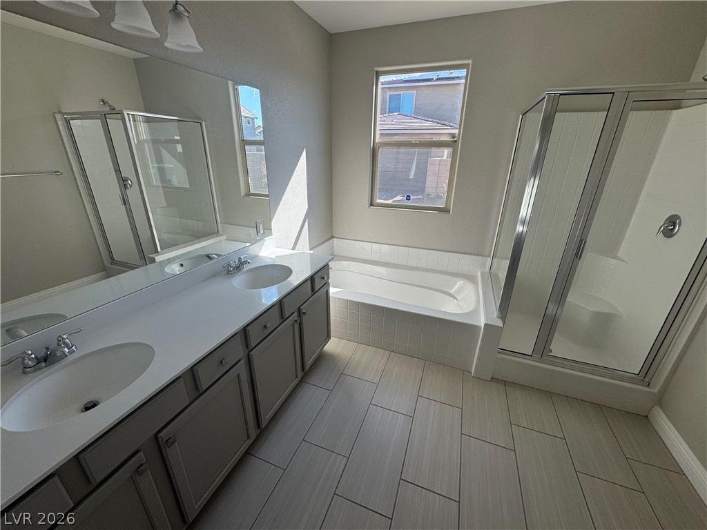 1051 East Sunset Road Henderson, NV 89011 - Photo 12 of 36 Bathroom with a stall shower, double vanity, and a garden tub