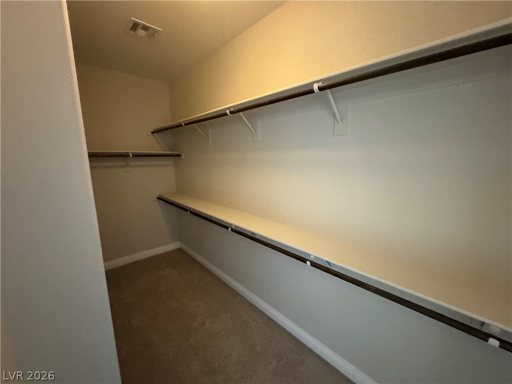 1051 East Sunset Road Henderson, NV 89011 - Photo 14 of 36 Walk in closet featuring dark carpet