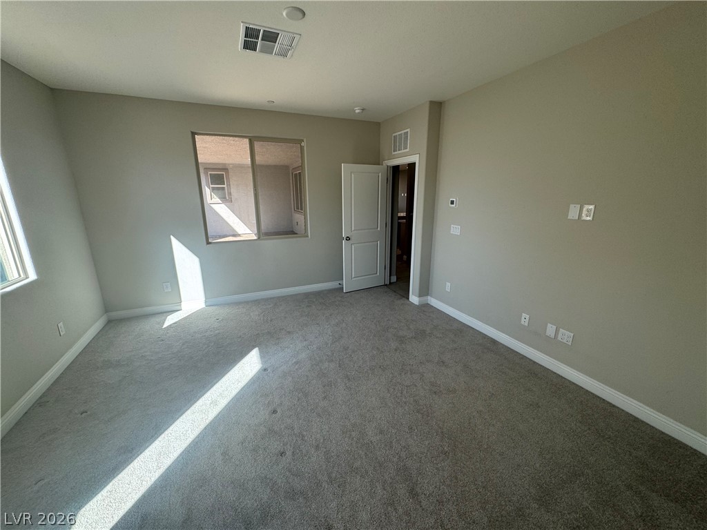 1051 East Sunset Road Henderson, NV 89011 - Photo 15 of 36 Unfurnished bedroom featuring baseboards and carpet floors