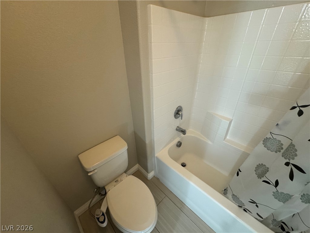 1051 East Sunset Road Henderson, NV 89011 - Photo 18 of 36 Bathroom featuring toilet and shower / bath combo