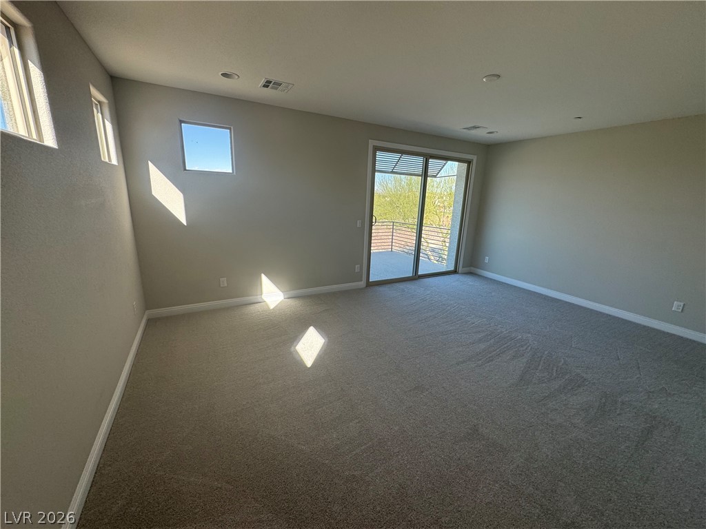 1051 East Sunset Road Henderson, NV 89011 - Photo 19 of 36 Carpeted spare room featuring baseboards