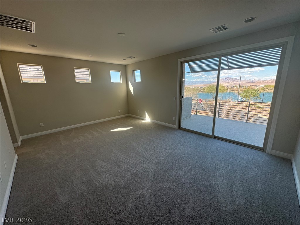1051 East Sunset Road Henderson, NV 89011 - Photo 21 of 36 Unfurnished room with dark colored carpet and a water view