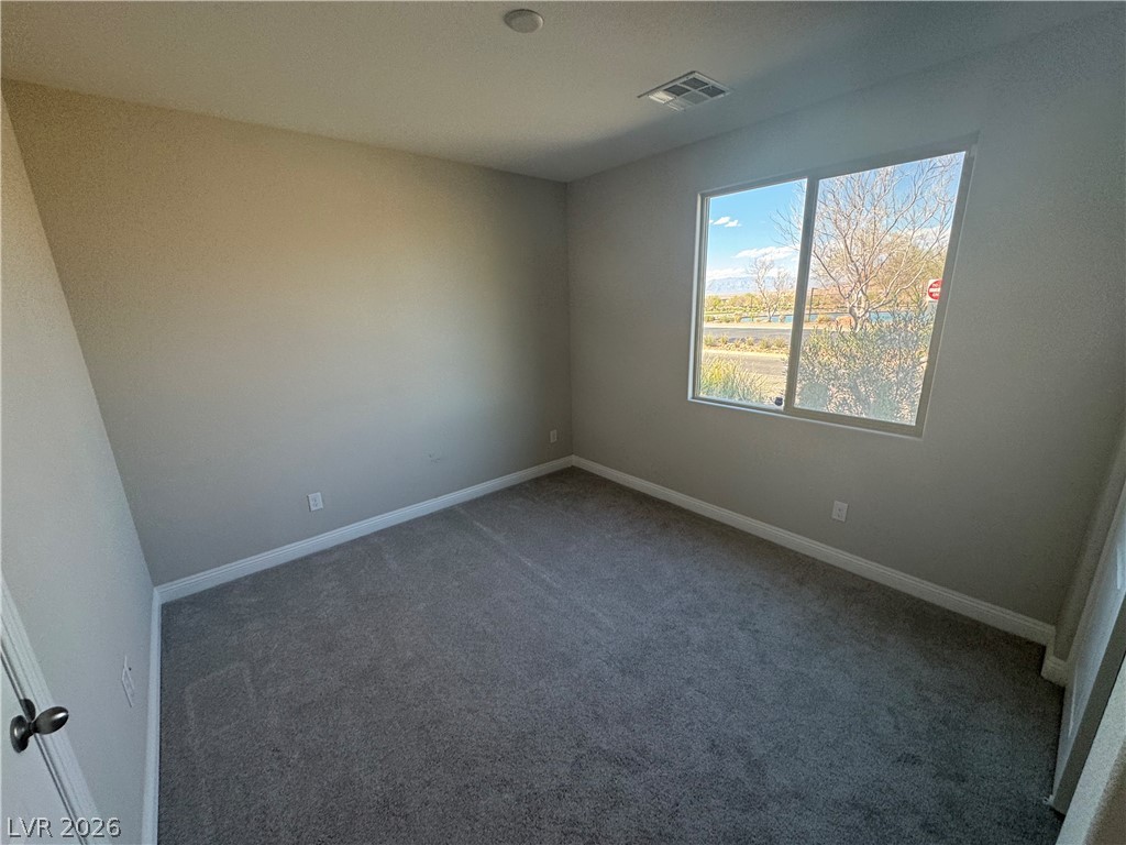 1051 East Sunset Road Henderson, NV 89011 - Photo 24 of 36 Carpeted spare room featuring baseboards