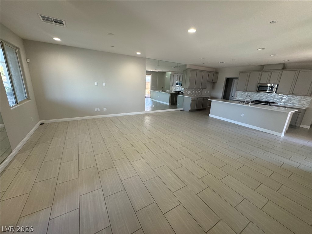 1051 East Sunset Road Henderson, NV 89011 - Photo 6 of 36 Unfurnished living room featuring wood finish floors and recessed lighting