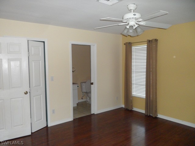 18395 Fern Road Fort Myers, FL 33967 - Photo 16 of 21 an empty room with wooden floor chandelier fan and windows