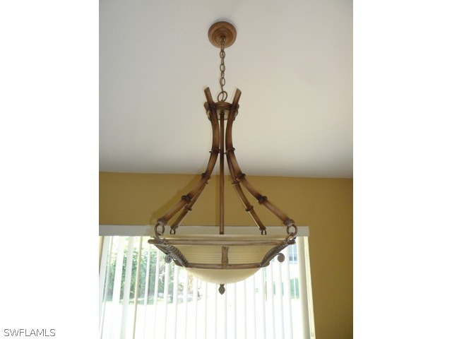 18395 Fern Road Fort Myers, FL 33967 - Photo 7 of 21 a room with a table and a chandelier
