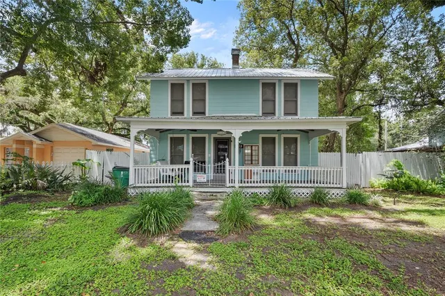 a front view of a house with a yard table and chairs
