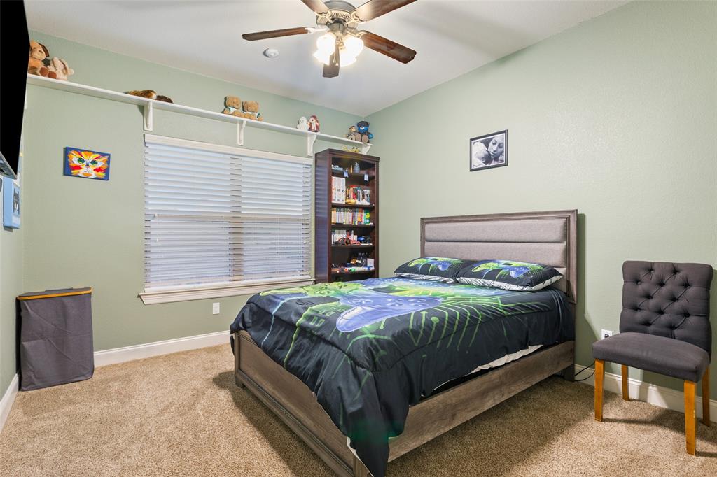 2313 Nicholas Waco, TX 76712 - Photo 21 of 36 a bedroom with a bed and a chandelier