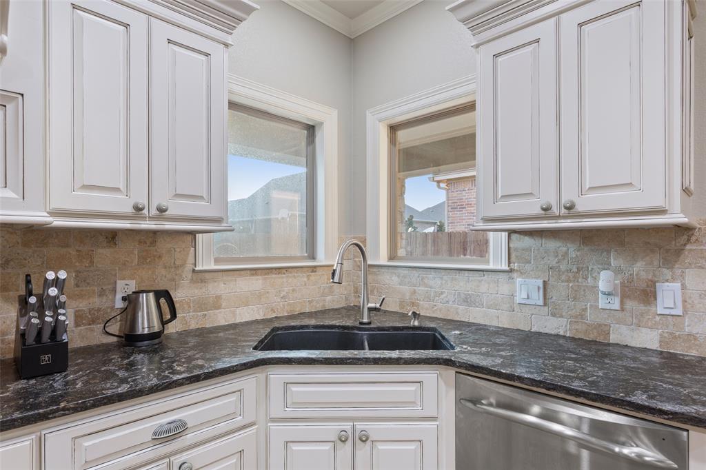 2313 Nicholas Waco, TX 76712 - Photo 10 of 36 a kitchen with granite countertop a sink stainless steel appliances and cabinets