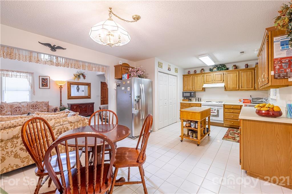 115 Banksridge Road Fort Mill, SC 29715 - Photo 17 of 29 a view of a dining room with furniture and a kitchen