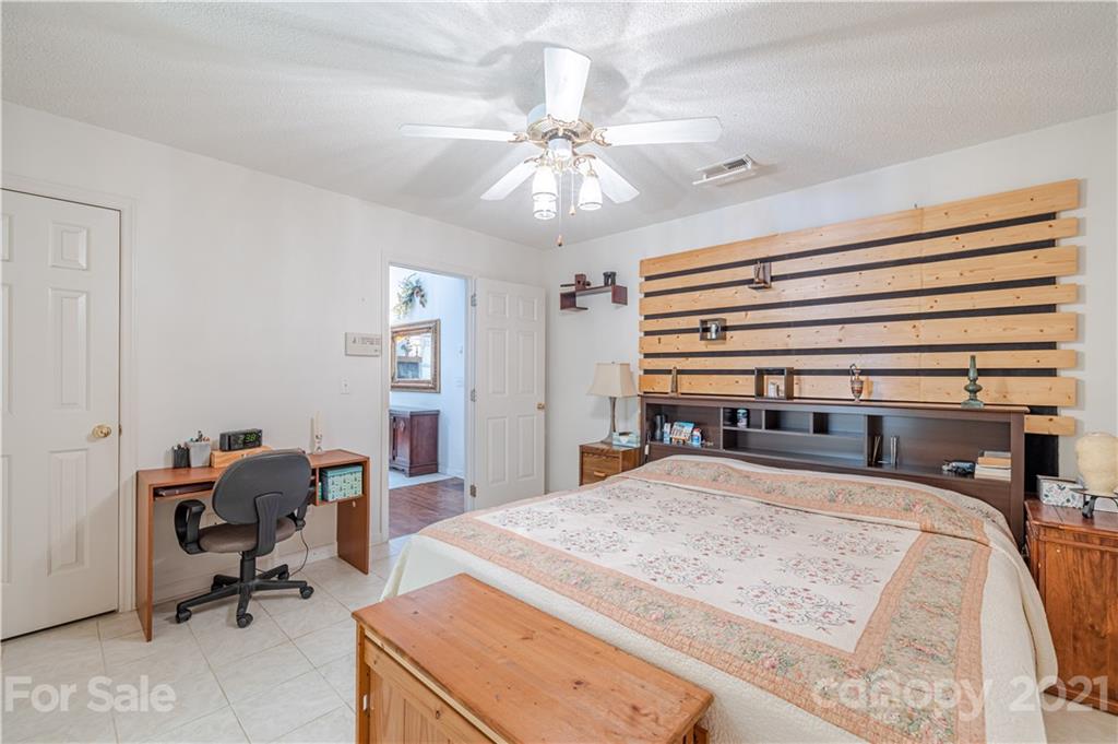 115 Banksridge Road Fort Mill, SC 29715 - Photo 22 of 29 a bedroom with a bed and a chandelier