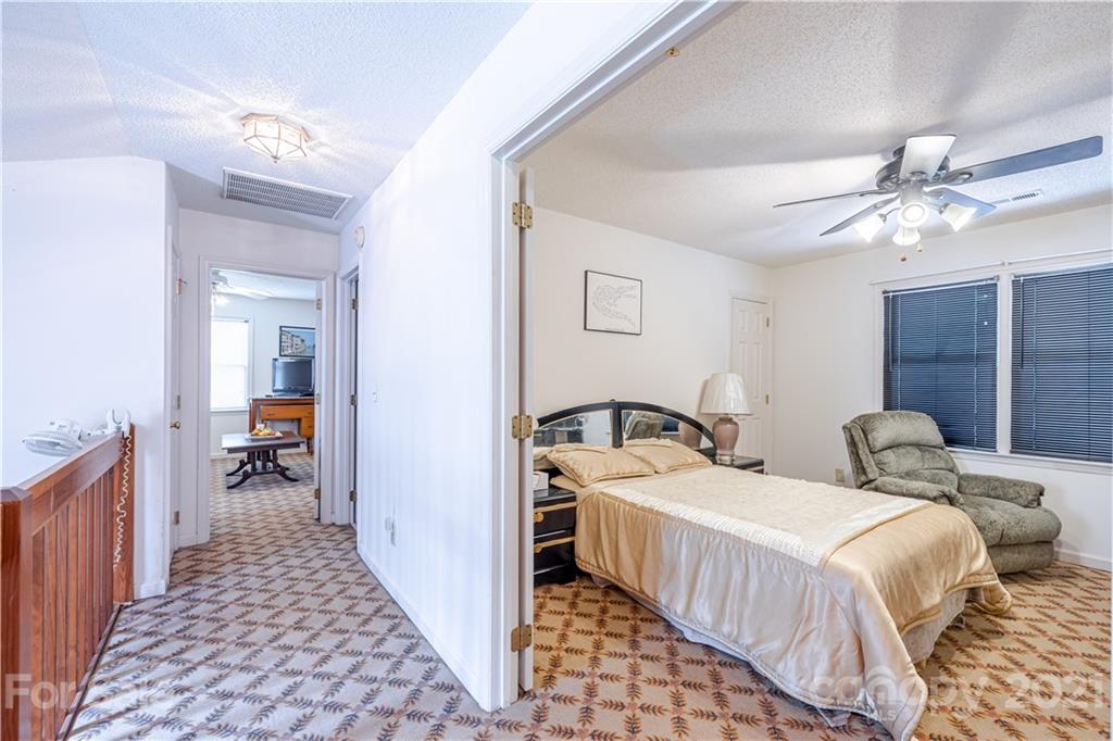 115 Banksridge Road Fort Mill, SC 29715 - Photo 26 of 29 a bedroom with two beds and a chandelier