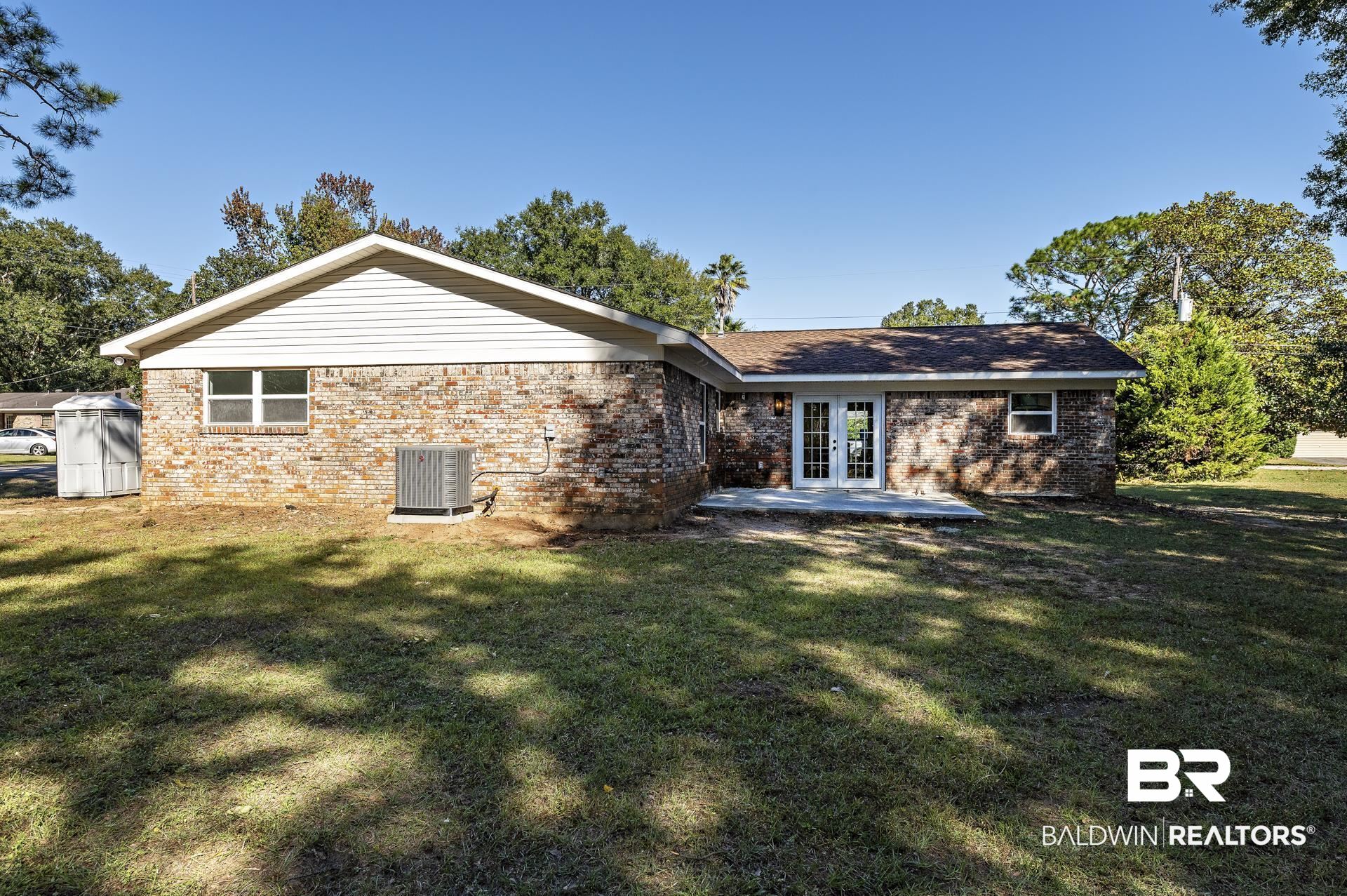 6001 Camp Halls Mill Road Mobile, AL 36619 - Photo 48 of 52 Back of house featuring brick siding, french doors, a patio area, and a yard