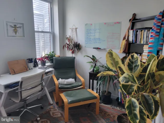 a living room with furniture and a book shelf