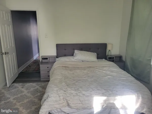 a bedroom with a bed and a mirror