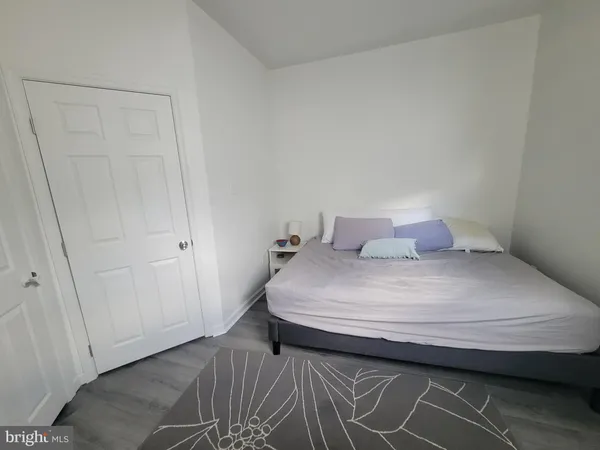 a bedroom with a bed and a closet