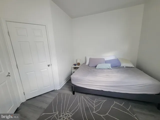 a bedroom with a bed and a closet