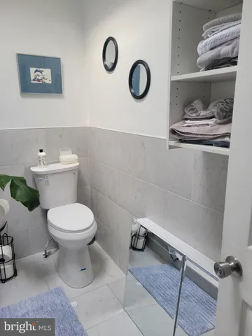 a bathroom with a toilet and a mirror