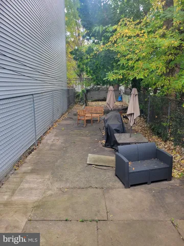 a view of patio with couches and a fire pit