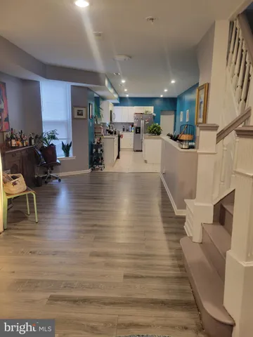 a view of a living room with kitchen